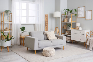 Interior of living room with stadiometer, sofa and shelf units