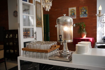 Elegant Beverage Dispenser and Glassware Setup in a Classic Interior