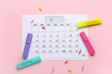 Calendar with pins and markers on pink background. Planning concept