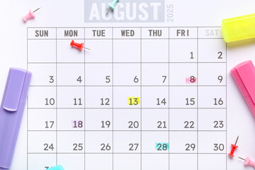 Calendar with pins and markers as background, closeup. Planning concept
