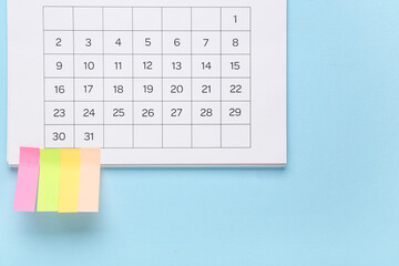 Calendar with sticky notes on blue background. Planning concept