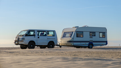 Scenic coastal road trip in Denmark with a vintage camper and van at sunset