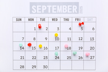 Calendar with pins as background, closeup. Planning concept