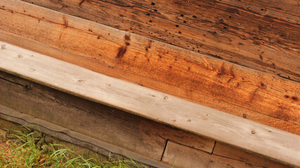Rustic Wooden Step or Bench Beside Old Timber Wall on Countryside Property