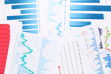 Many business documents with graphics as background, closeup