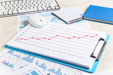 Notebooks with keyboard, computer mouse, many business graphics and diagrams on white background
