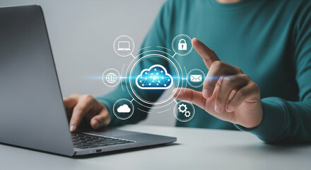 Person interacting with cloud computing interface on laptop