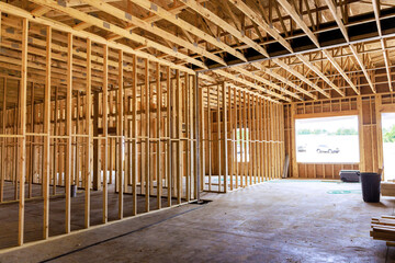 Wooden framing structure is taking shape inside building, revealing an open layout under natural...