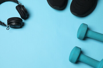 Set of sports equipment on blue background, top view