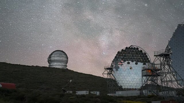 Majestic view of telescopes at Roque de los Muchachos Observatory under a starry sky, timelapse