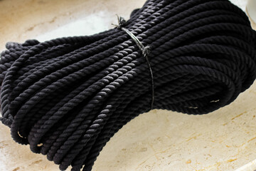 Neatly Bundled Black Synthetic Rope for Boating, Survival, and Industrial Applications