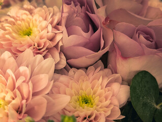 Vertical photo of a delicate bouquet with pale pink roses and chrysanthemums
