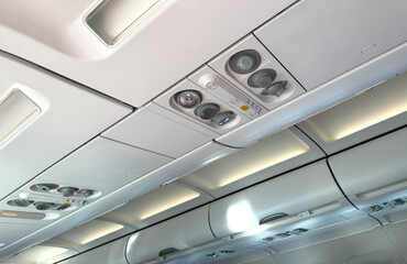 modern Airplane cabin interior, overhead panel with seatbelt and call buttons, reading light, call...