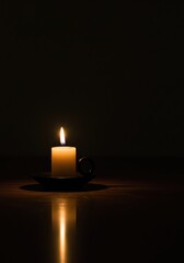 Solemn single candle lit in complete darkness with a warm reflection, symbolizing hope, remembrance, faith, and meditation.