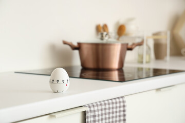 Kitchen timer near stove on counter in room, closeup