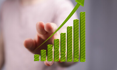 Image of a hand interacting with a 3D bar graph showing significant growth and upward trend.
