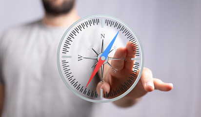 A person interacts with a digital compass, showing direction and navigation. Ideal for business,...