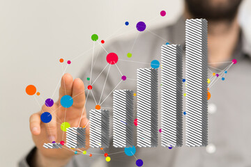 Stock photo of a hand interacting with a 3D bar chart showing growth and data connections.