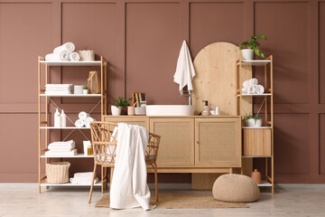 Interior of bathroom with shelf units, sink and plants