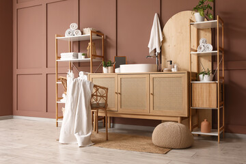 Interior of bathroom with shelf units, sink and plants
