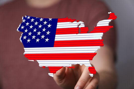 Image of a person holding a digital map of the United States designed in the style of the American flag.