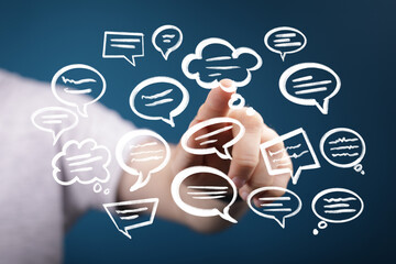 Abstract image of hand interacting with floating speech bubbles.  Perfect for communication, social...