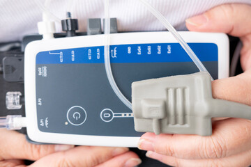 Portable 24-hour sleep monitoring device worn on woman's abdomen, combined with fingertip pulse...