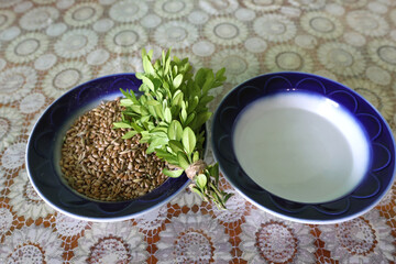 Holy water, wheat, and sprinkling for religious consecration.