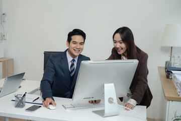 Fototapeta premium Business team analyzing documents, graphs, and data with a laptop, tablet, and smartphone. Collaboration, strategy, and success in a modern office.