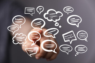 Image depicts a hand interacting with digital speech bubbles, symbolizing communication, ideas, and...
