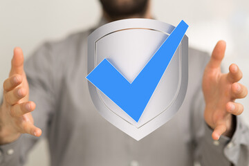 High-quality image of a person presenting a digital shield with a checkmark, symbolizing security...