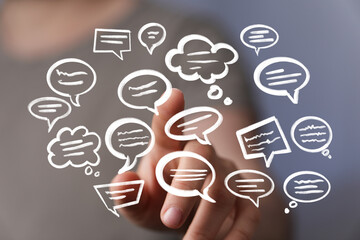 Abstract image of hand interacting with digital speech bubbles, representing communication and...
