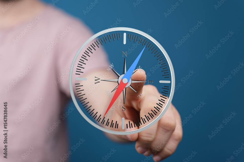Aufkleber Close-up of a finger interacting with a digital compass, showing navigation and direction finding.