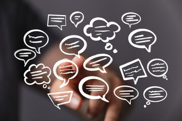 Hand interacting with floating speech bubbles,concept of communication, dialogue, and sharing ideas.
