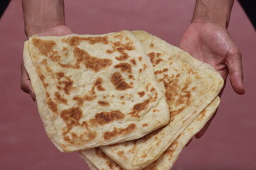 Hands holding Moroccan Msemmen or Msemen, Traditional moroccan flatbread