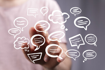 Image of hand interacting with digital speech bubbles, representing communication, conversation,...