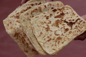 Hands holding Moroccan Msemmen or Msemen, Traditional moroccan flatbread