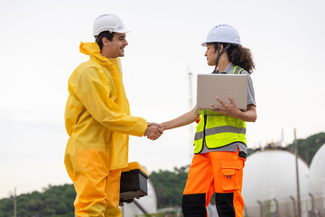 Environmental Workers Inspecting Industrial Site, Team in Protective Gear Surveying Contaminated Area, Engineer and Environmental Worker Shaking Hands at a Chemical Plant