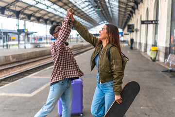 Happy tourists giving high five at train station