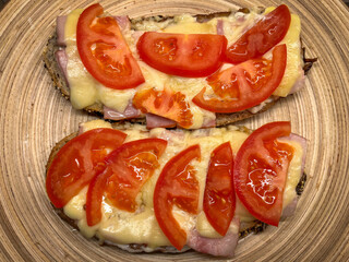 Cheese and tomato toasts on a bamboo plate