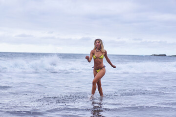 Fototapeta premium Bikini model posing on volcanic beach