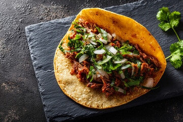Street-style taco with beef, cilantro and onions on tortilla