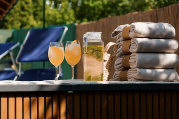 Relaxing Backyard Hot Tub Scene with Refreshments: Summer Spa Day with Cocktails, Towels, and...