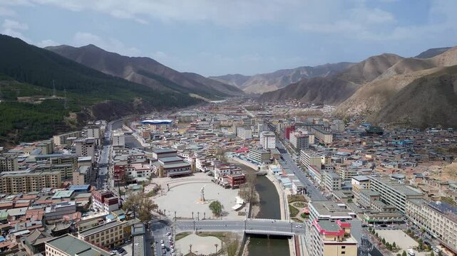 Xiahe, China: Aerial drone forward footage of the Xiahe town in the Ganna prefecture in the Tibetan plateau, famous for the Labrang Monastery.