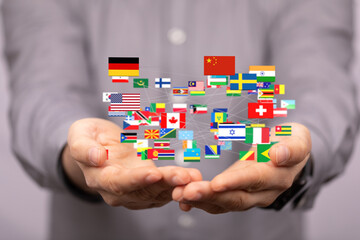 Image of hands holding a network of interconnected flags representing global connections.