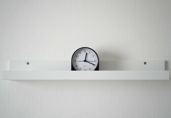 Minimalist Desk Clock on Shelf – White Wall Background