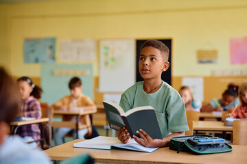 Fototapeta premium Black student learning during class at elementary school.