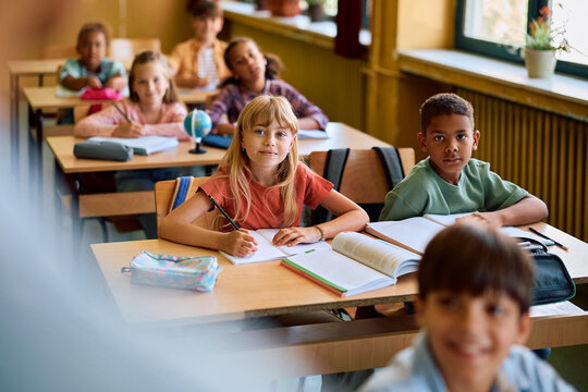 Multiracial group of elementary students during class in classroom.