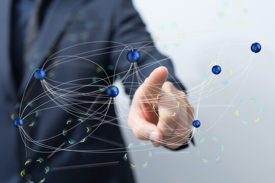 A businessman interacts with a digital network, symbolizing global connectivity and business technology.