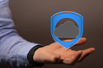 Image of a hand holding a digital shield protecting a cloud, symbolizing secure cloud data.